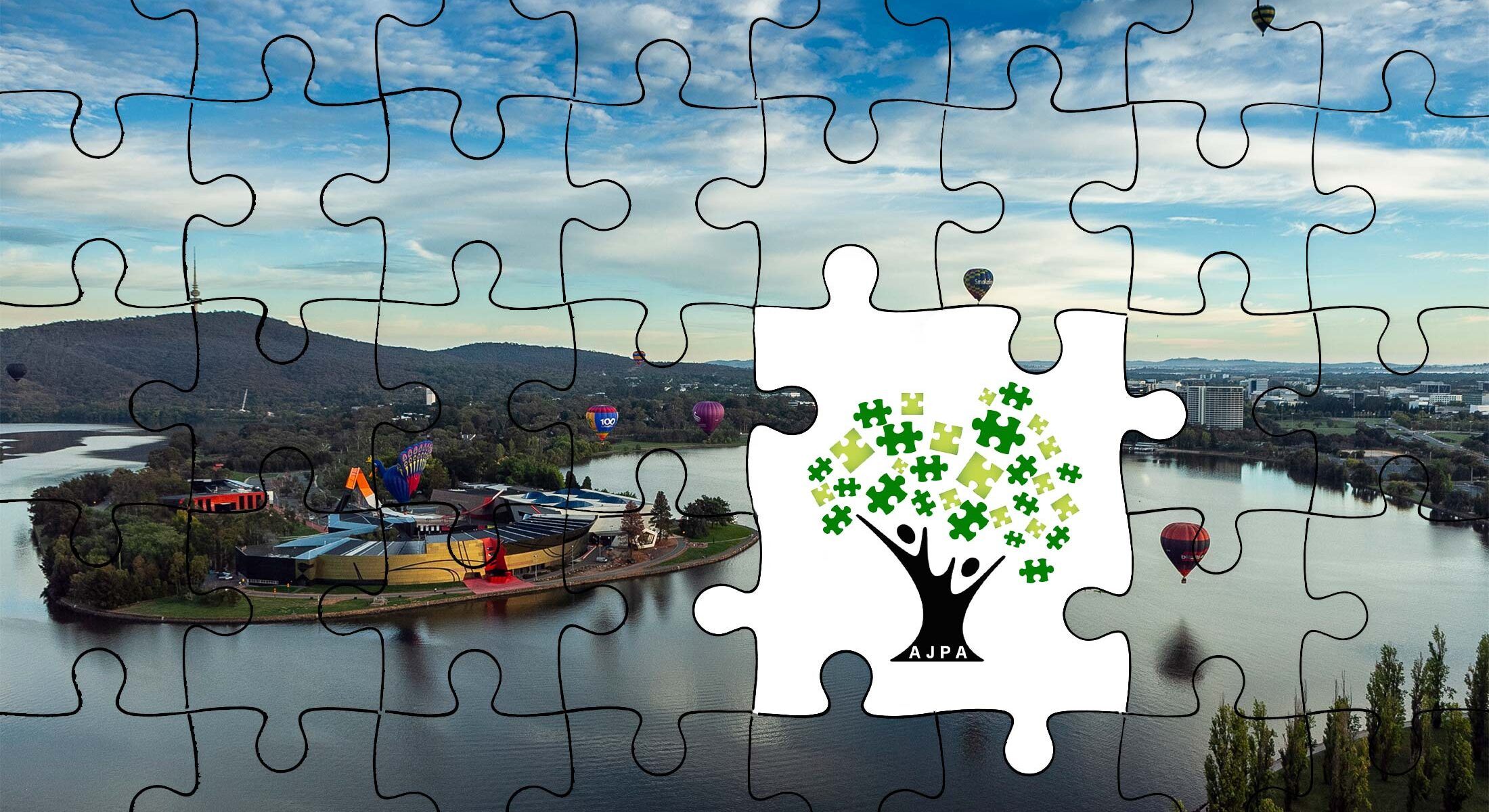 Image of Lake Burley Griffin as a puzzle with some pieces missing, revealing the Australian Jigsaw Puzzle Association logo